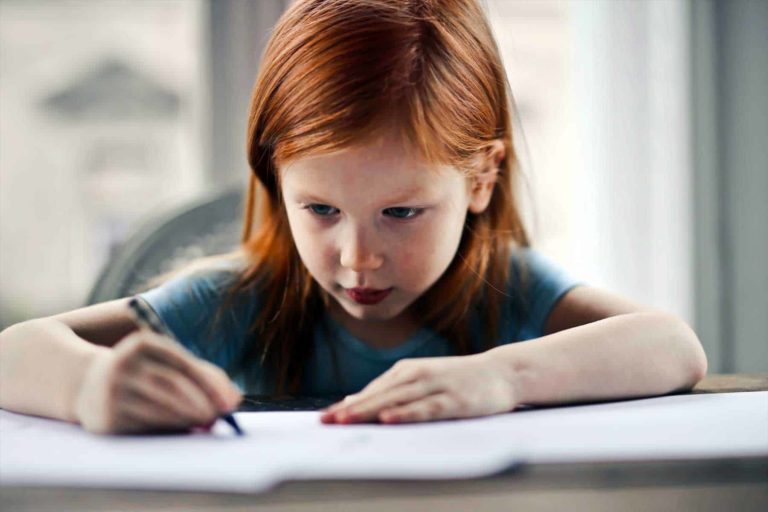 Red haired girl studying