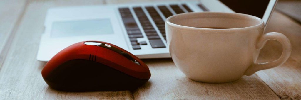 Red logitech mouse on computer-desk