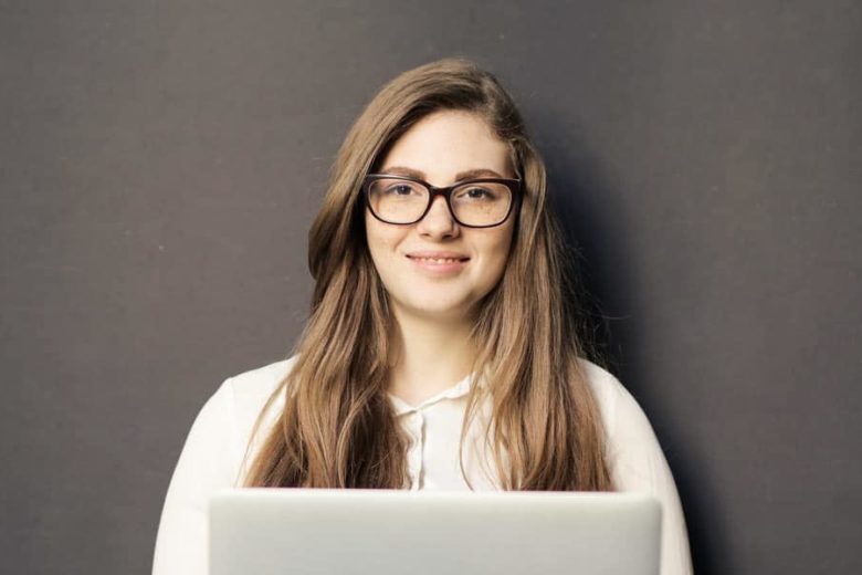 Woman smiling while using laptop