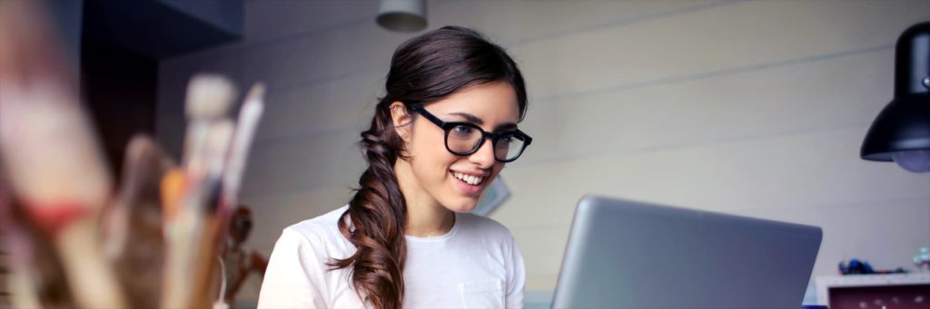 Woman using her laptop at work from home setting
